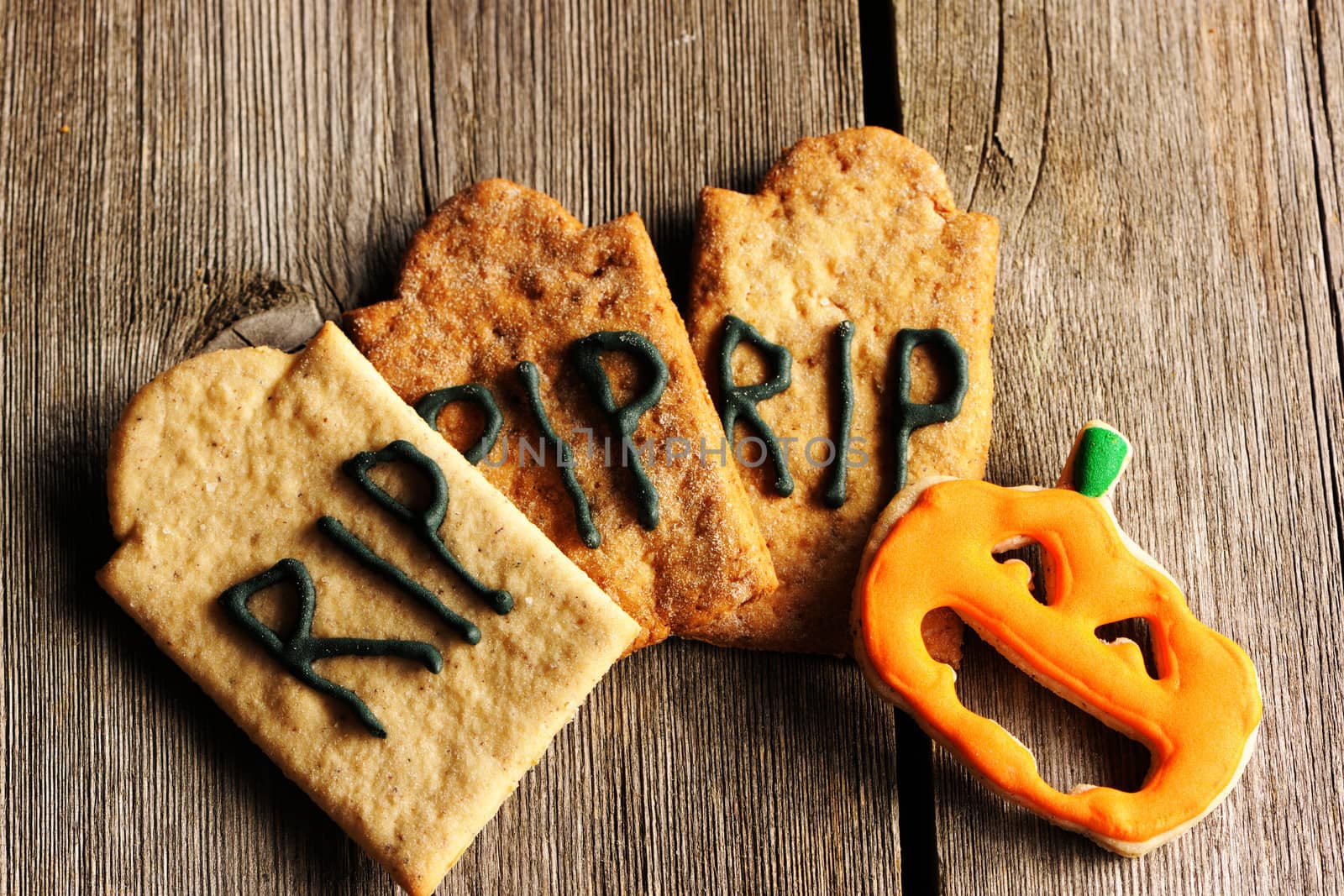 Halloween homemade gingerbread cookies over wooden table