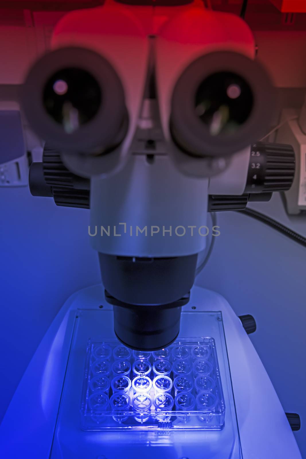 Microscope at a chemical laboratory in the mystical blue red light