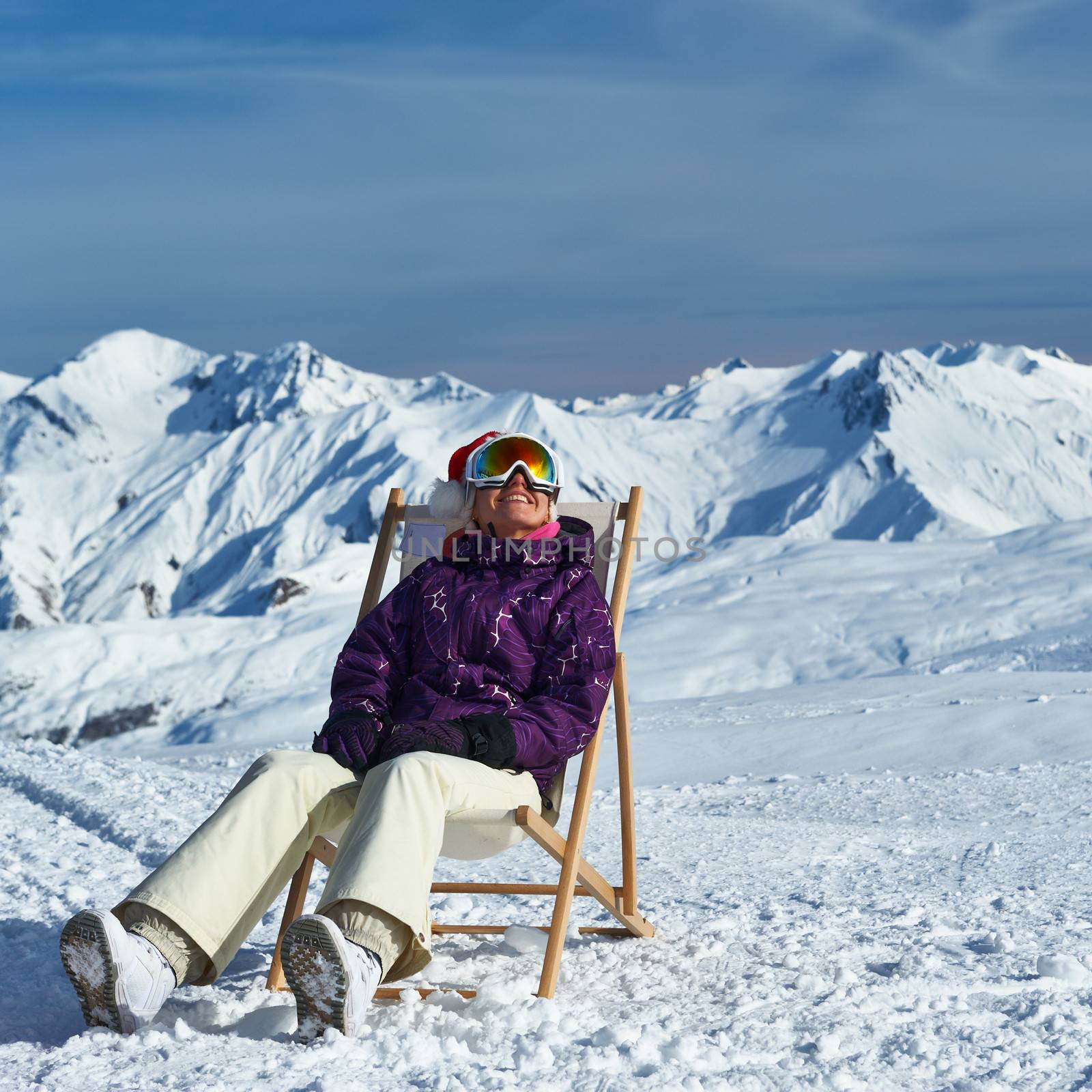 Woman at mountains in Santa hat celebrating christmas, Meribel, Alps, France