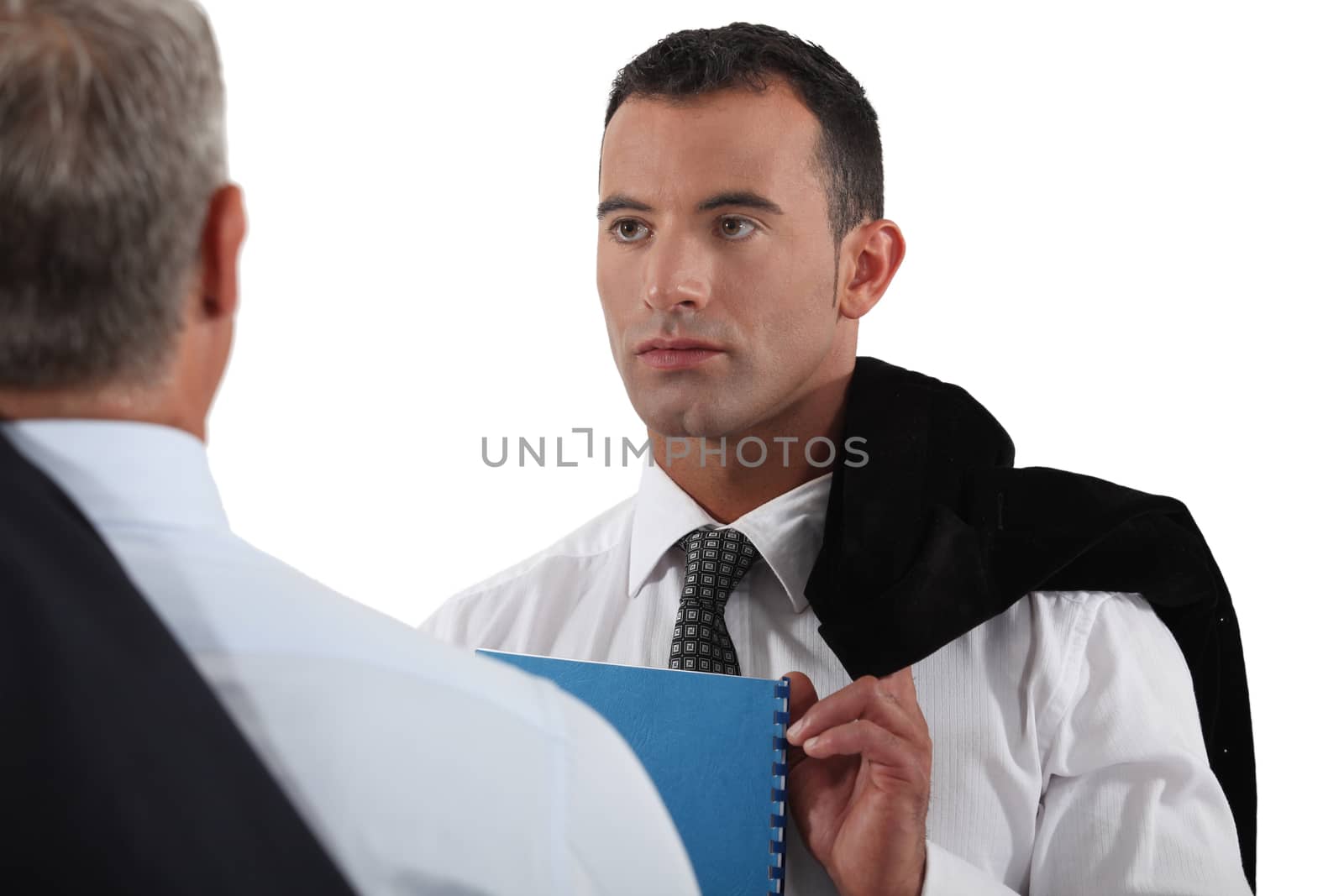 Young businessman listening to a senior colleague by phovoir