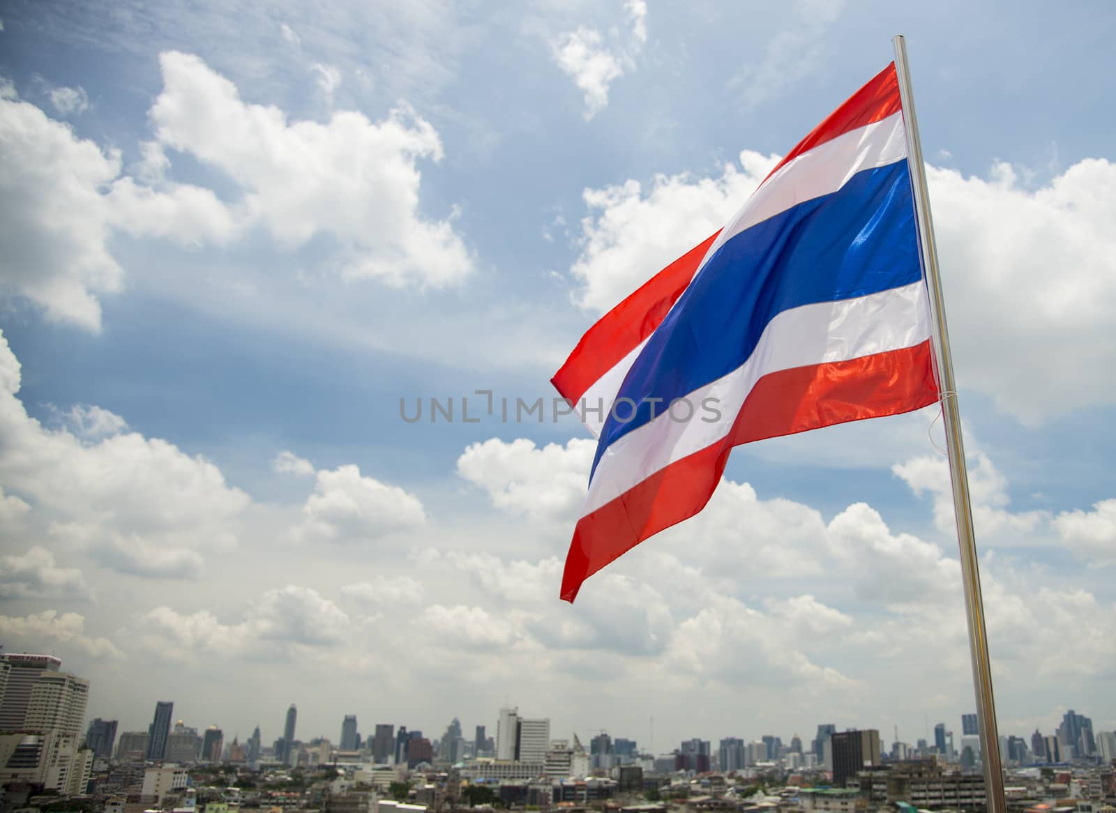Thailand flag with city background by gjeerawut
