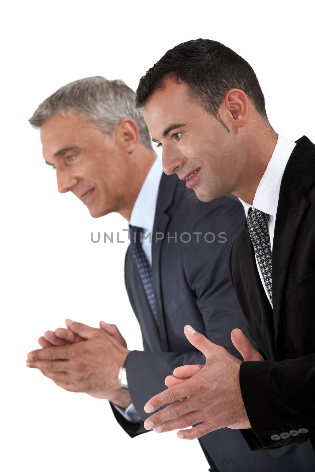 Two businessmen applauding by phovoir