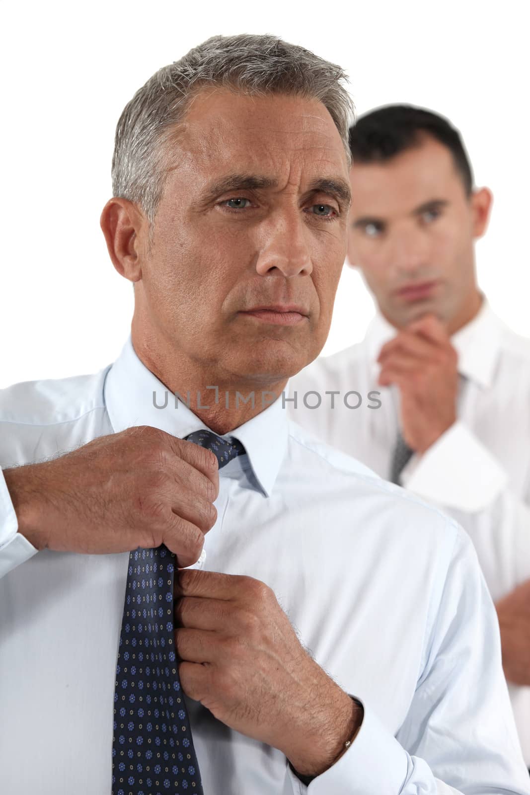 Businessman fixing his tie