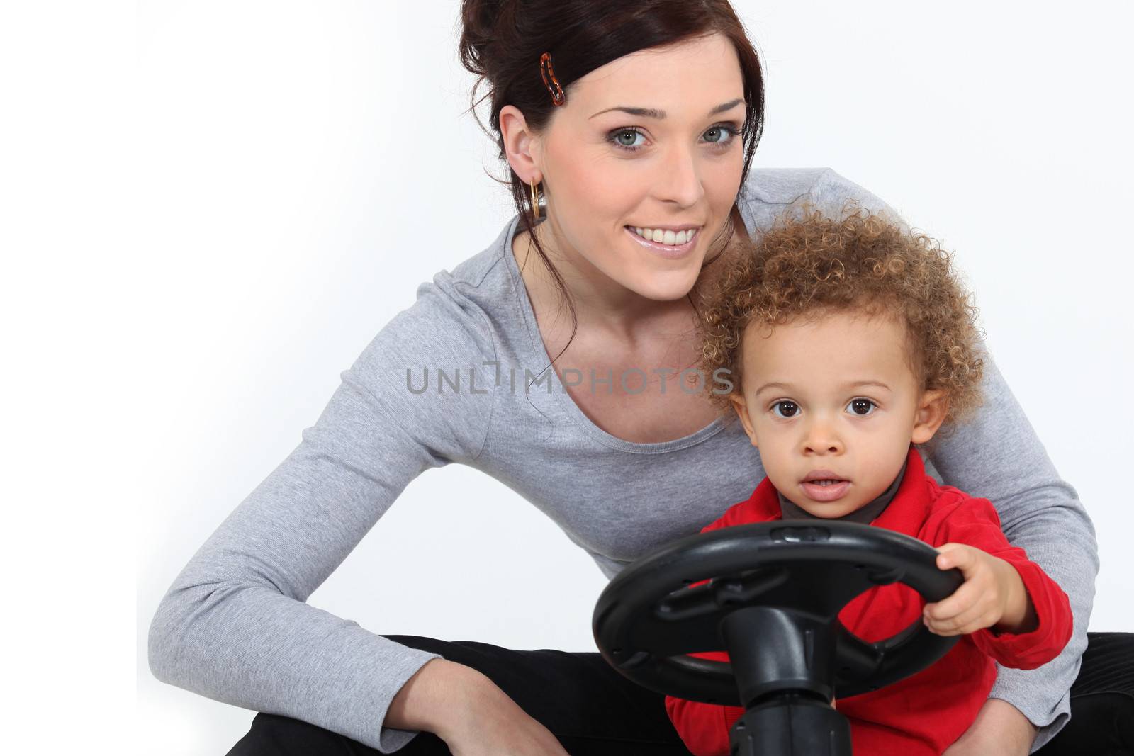 Woman and little boy on a toy car