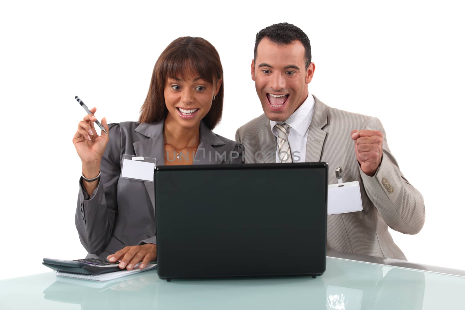 elated business duo with laptop by phovoir