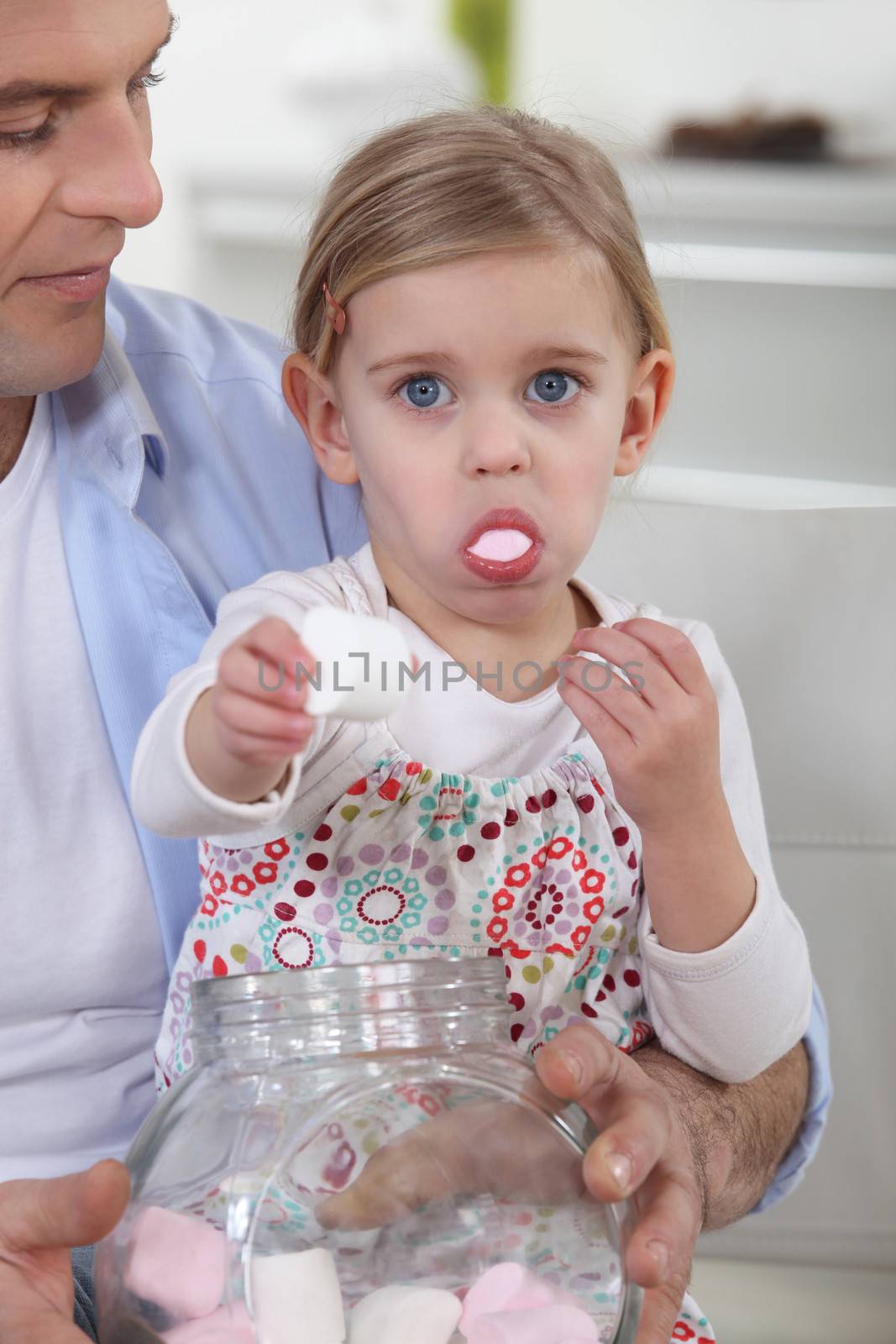 Little girl eating candy