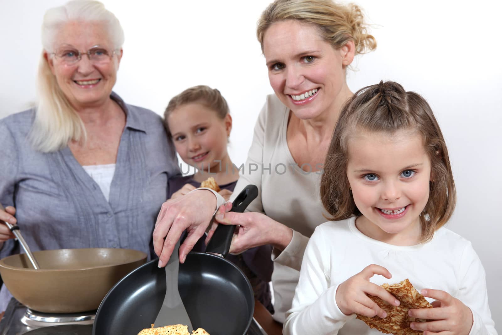 Three generations cooking pancakes by phovoir