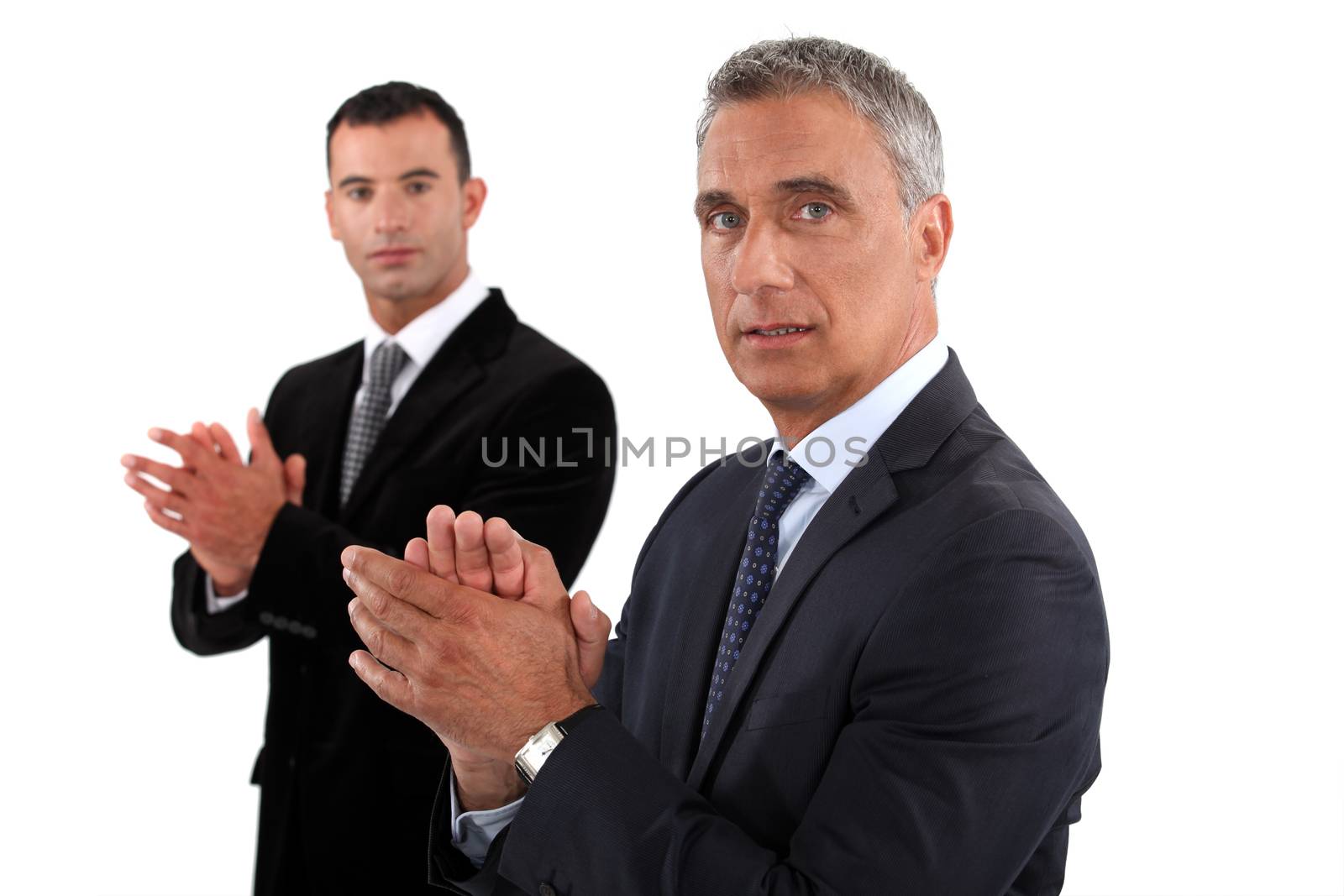 Businessmen rubbing their hands by phovoir