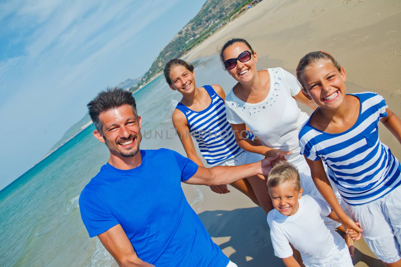 Family having fun on beach by maxoliki