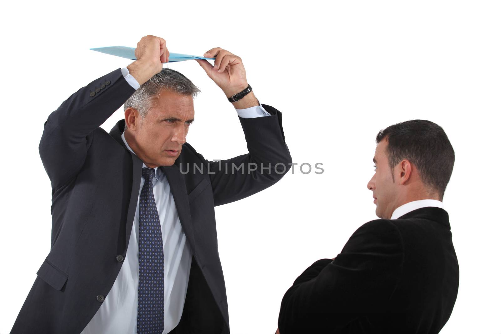 Angry boss about to hit employee with clip-board by phovoir