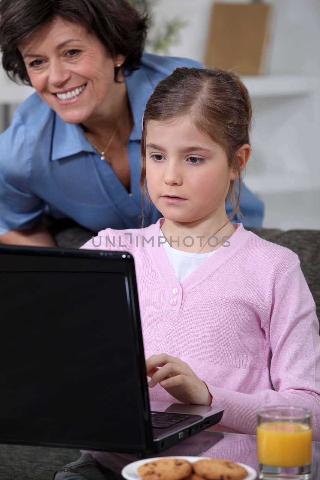 Little girl using laptop at home