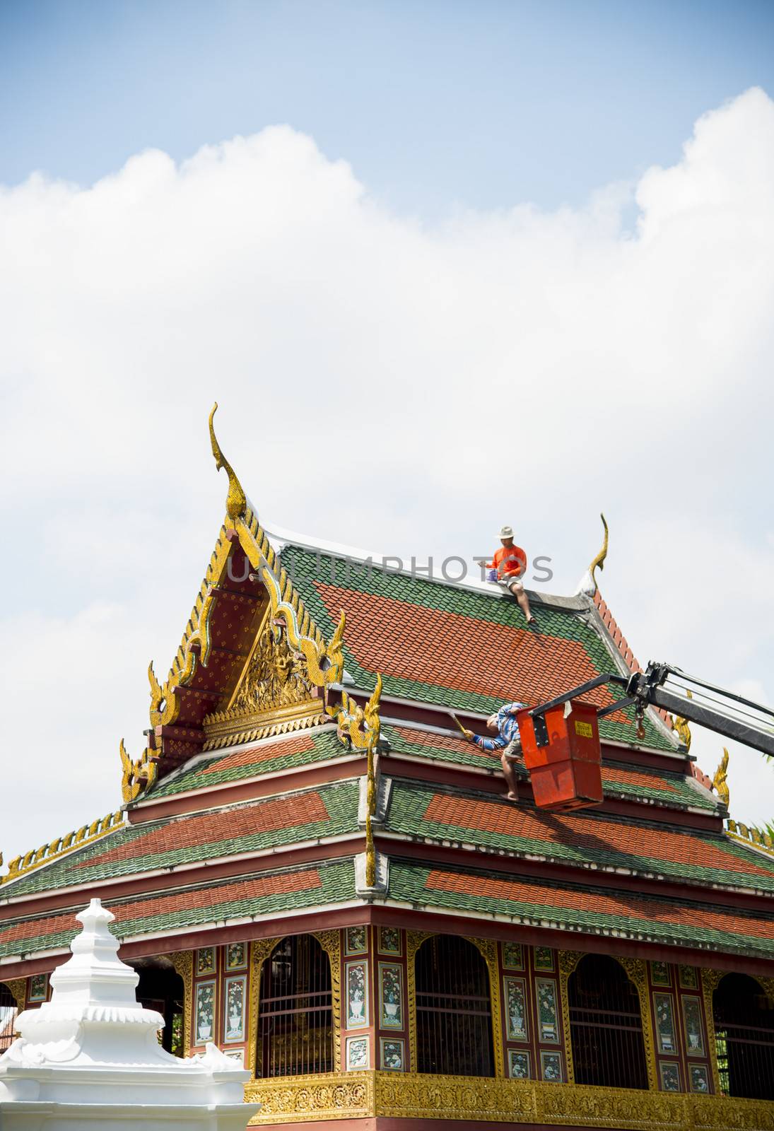 Men repair roof of Temple4 by gjeerawut