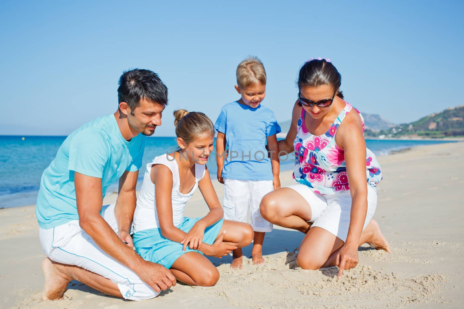 family having fun on beach by maxoliki