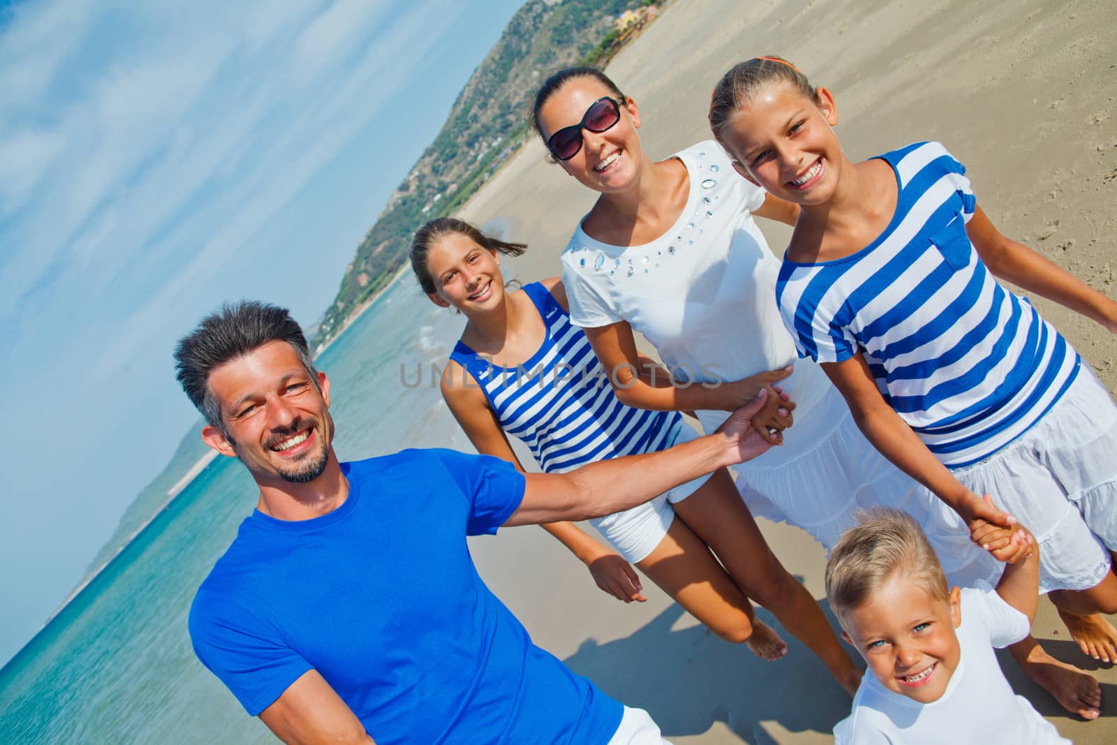 Family having fun on beach by maxoliki