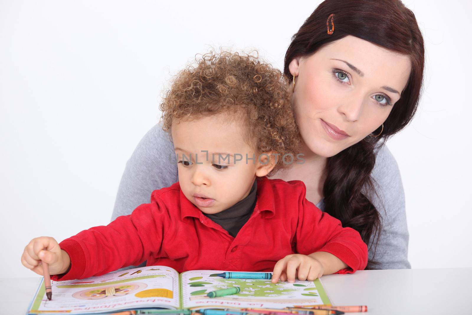 Mother and son reading book together