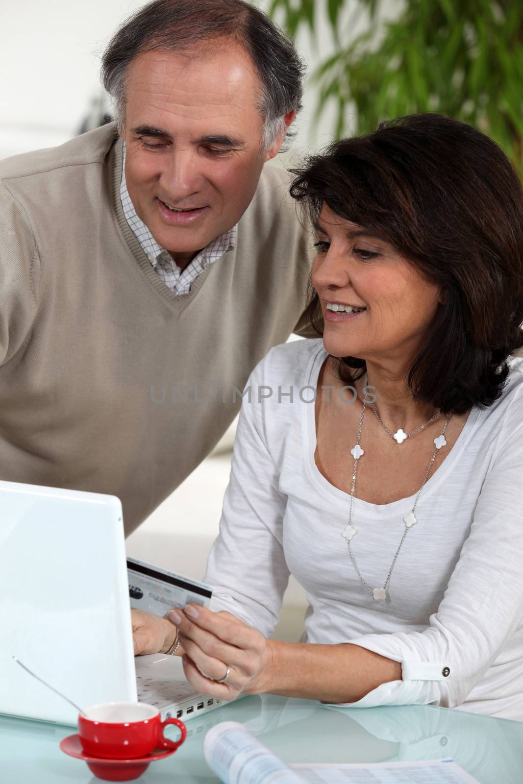 Middle-aged couple doing some on-line shopping