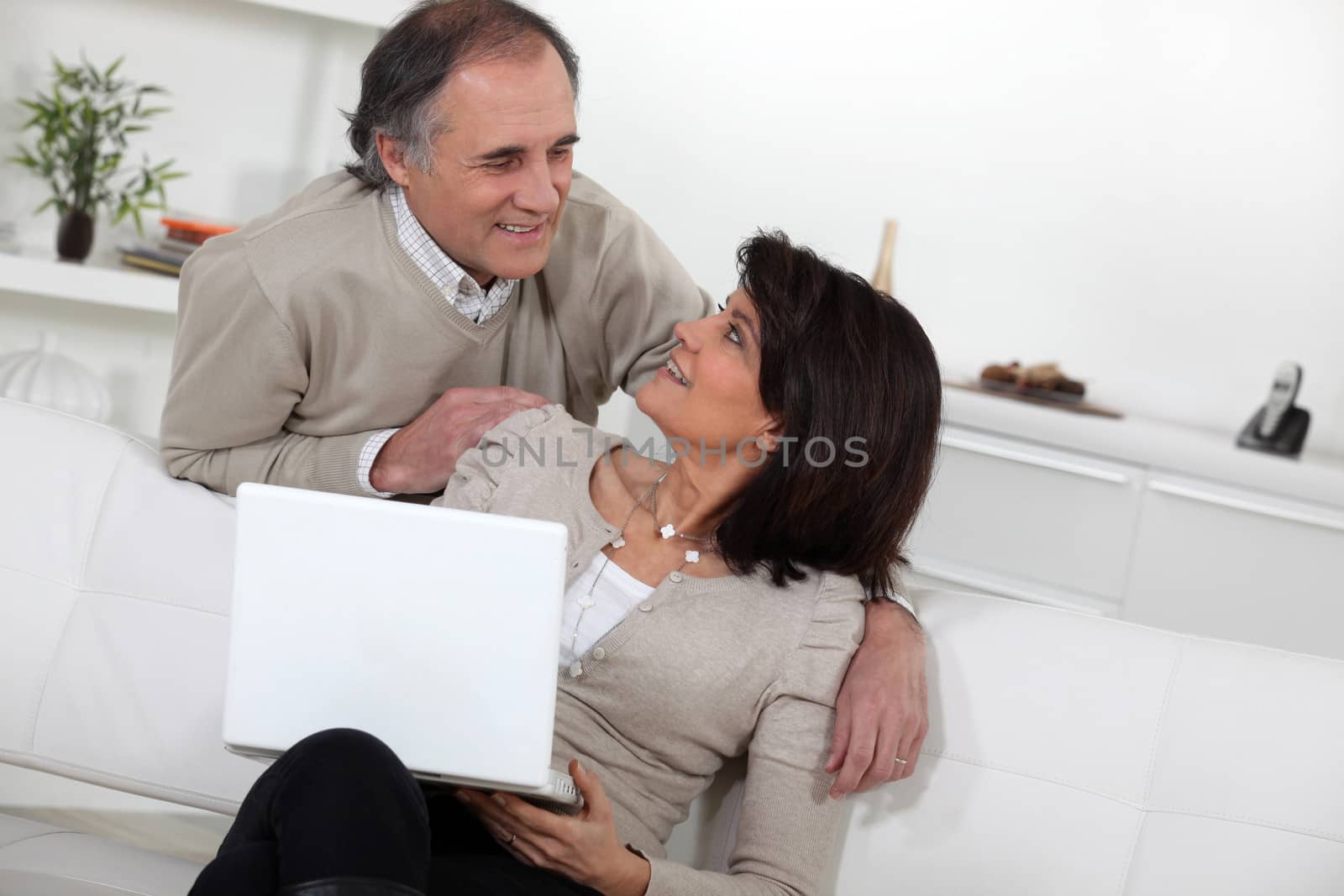 Married couple using laptop