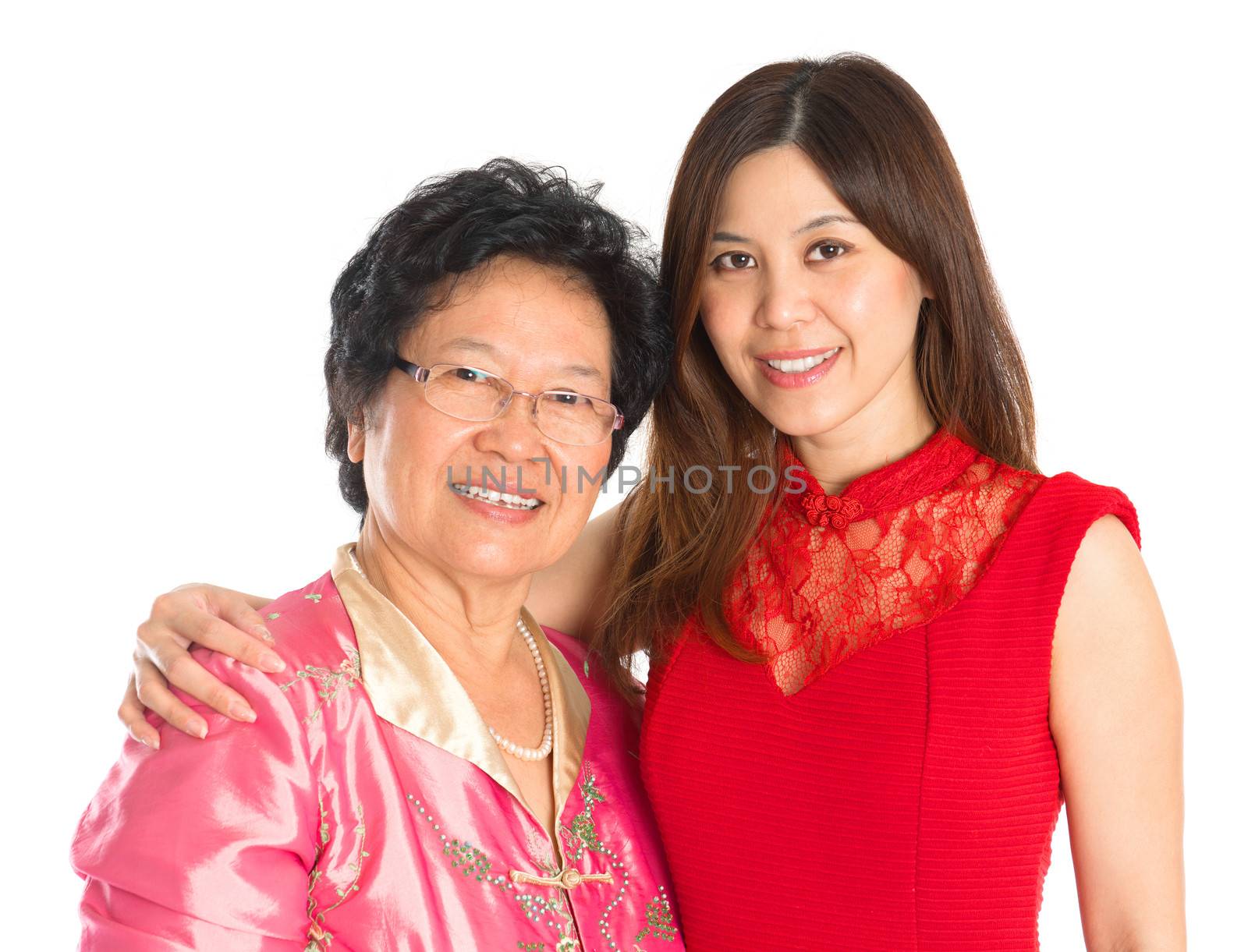 Chinese New Year festival. Happy Asian Chinese senior mother and adult daughter standing isolated on white background