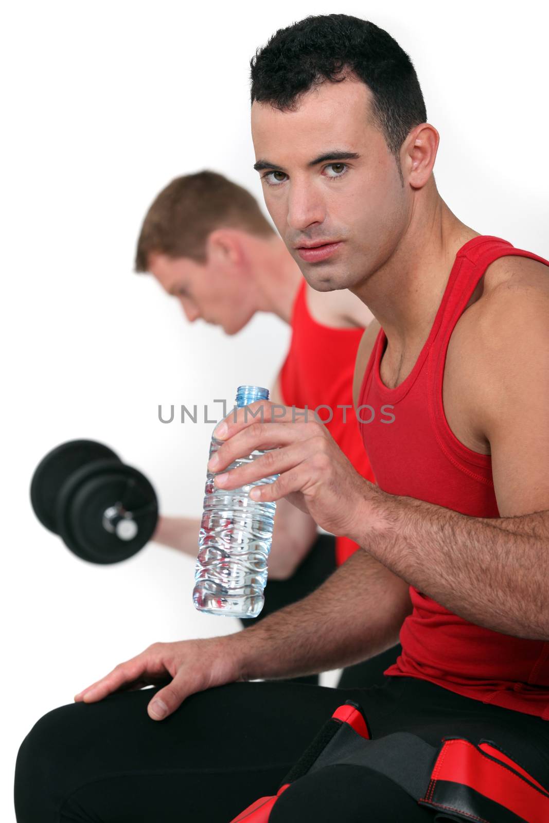 Two men working out at the gym by phovoir