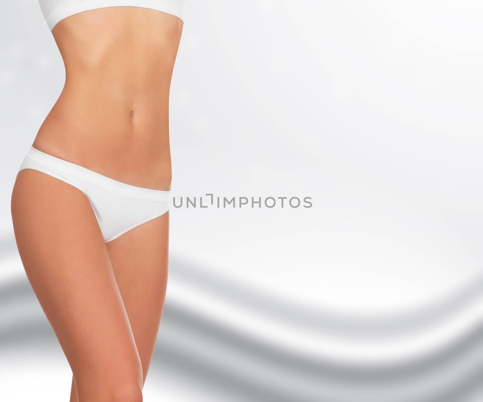 Slim woman body against an abstract background