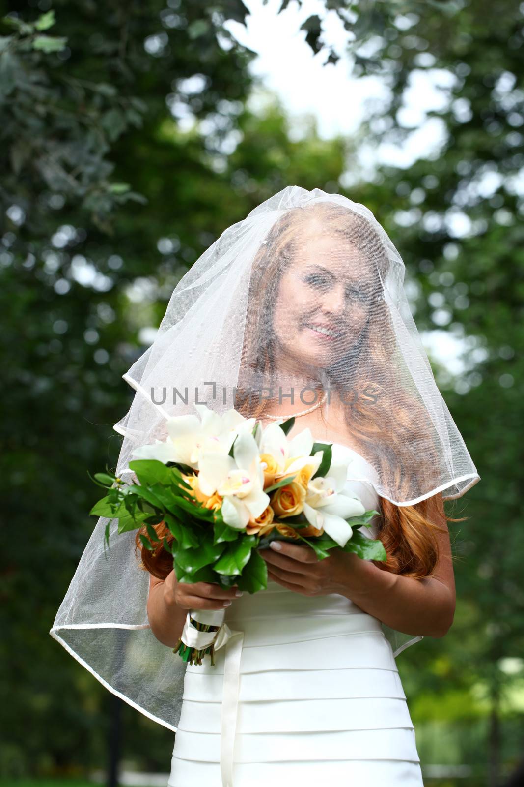 Portrait of beautiful bride with flowers