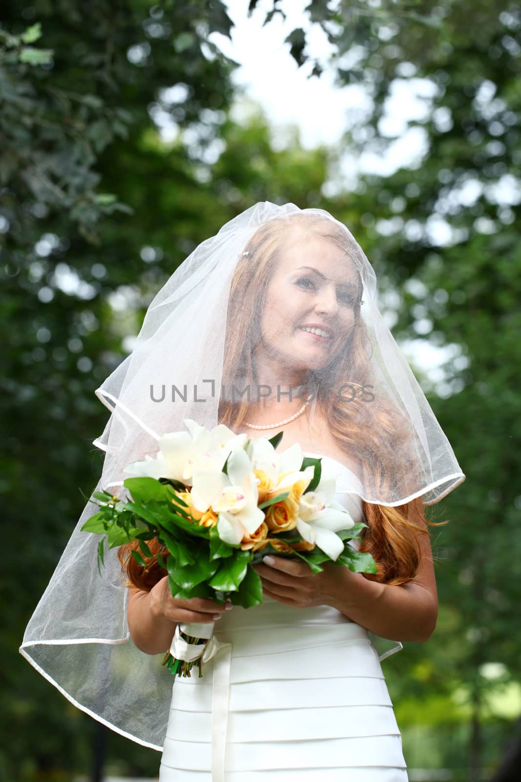 Portrait of beautiful bride with flowers