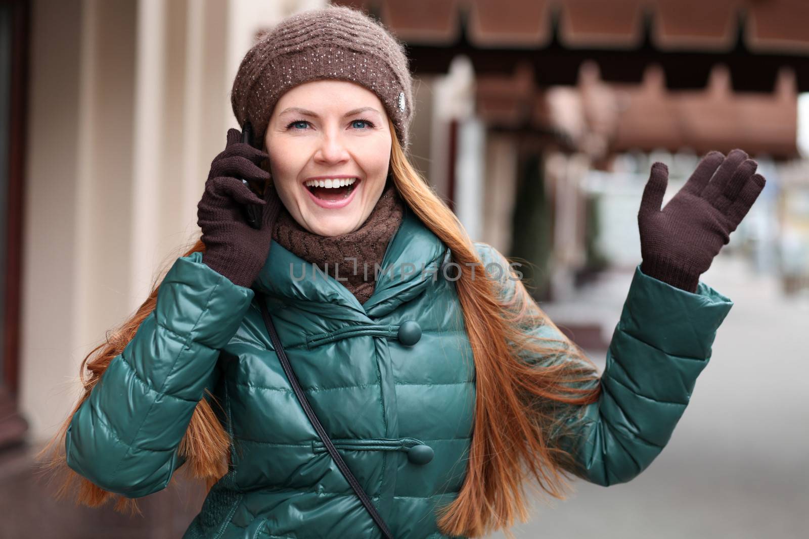 Happy young woman calling by phone