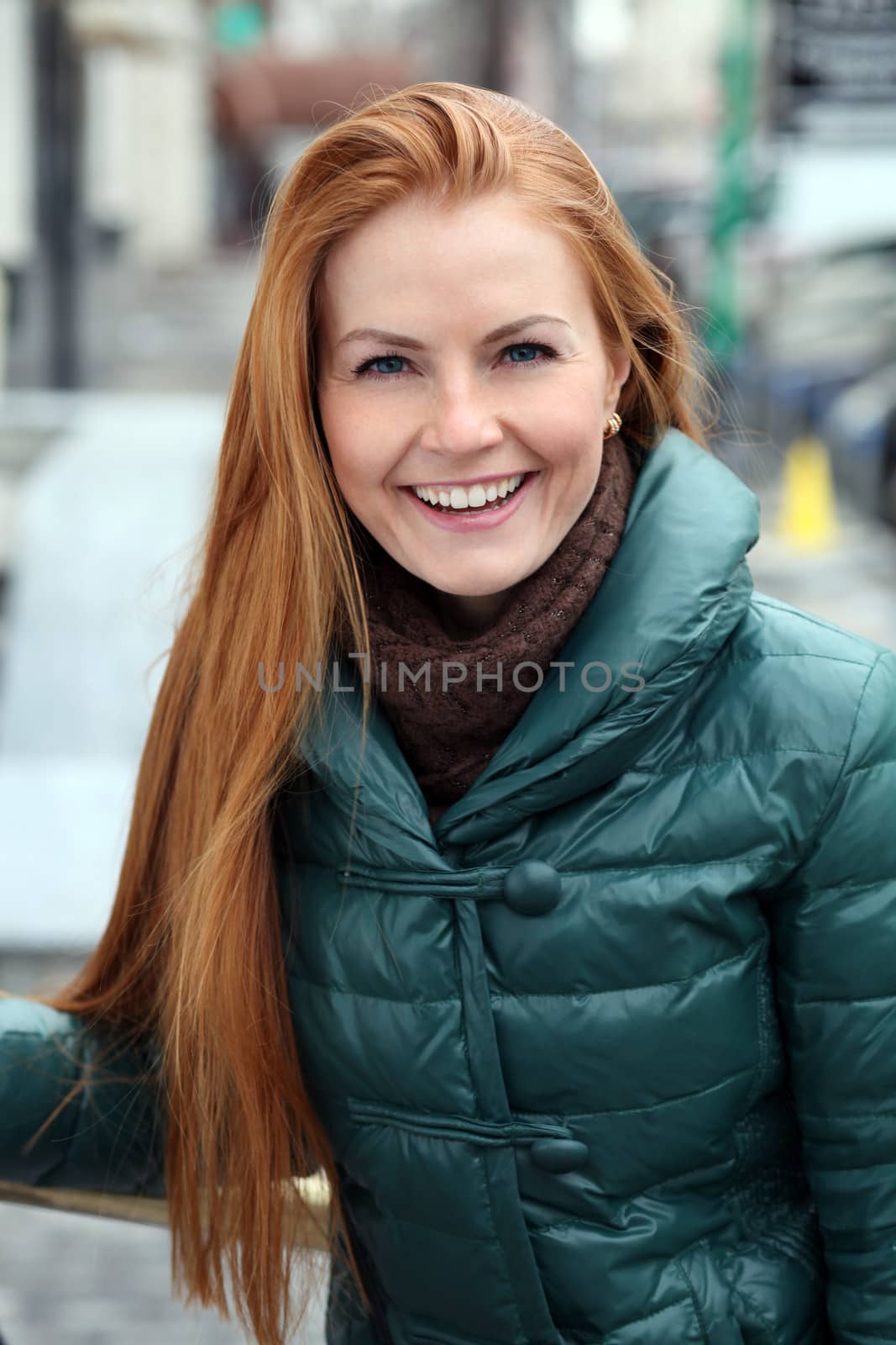 Happy young woman in autumn city by andersonrise