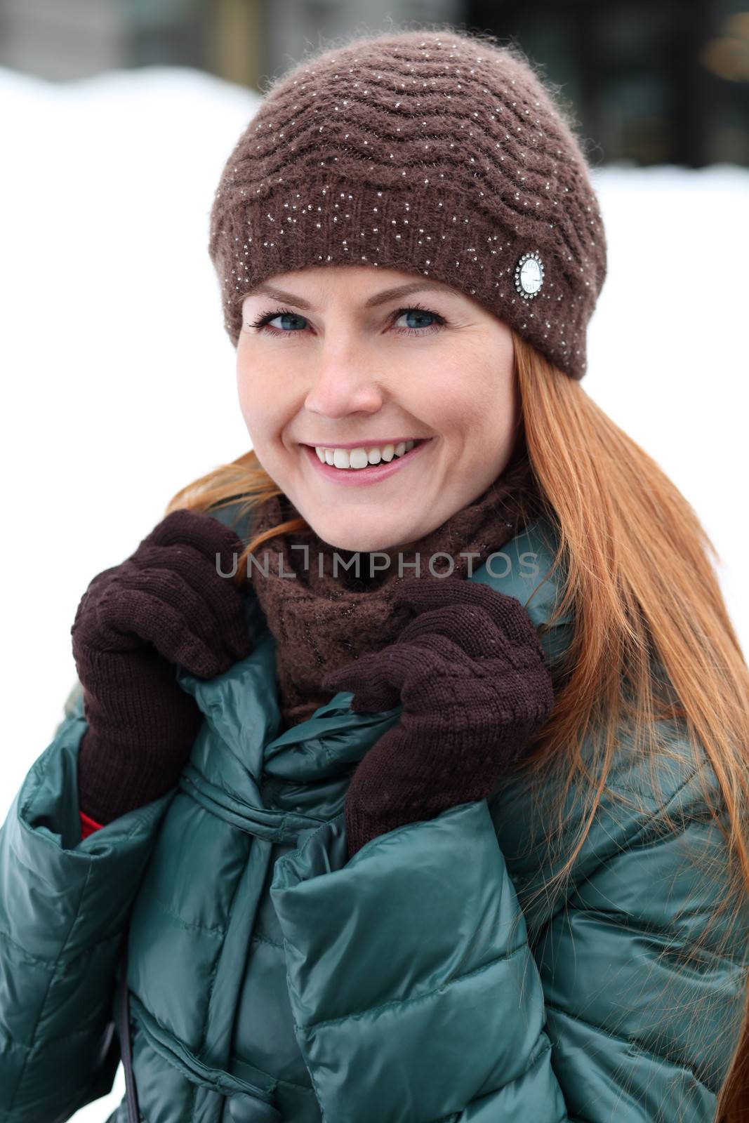 Happy young woman in winter city by andersonrise