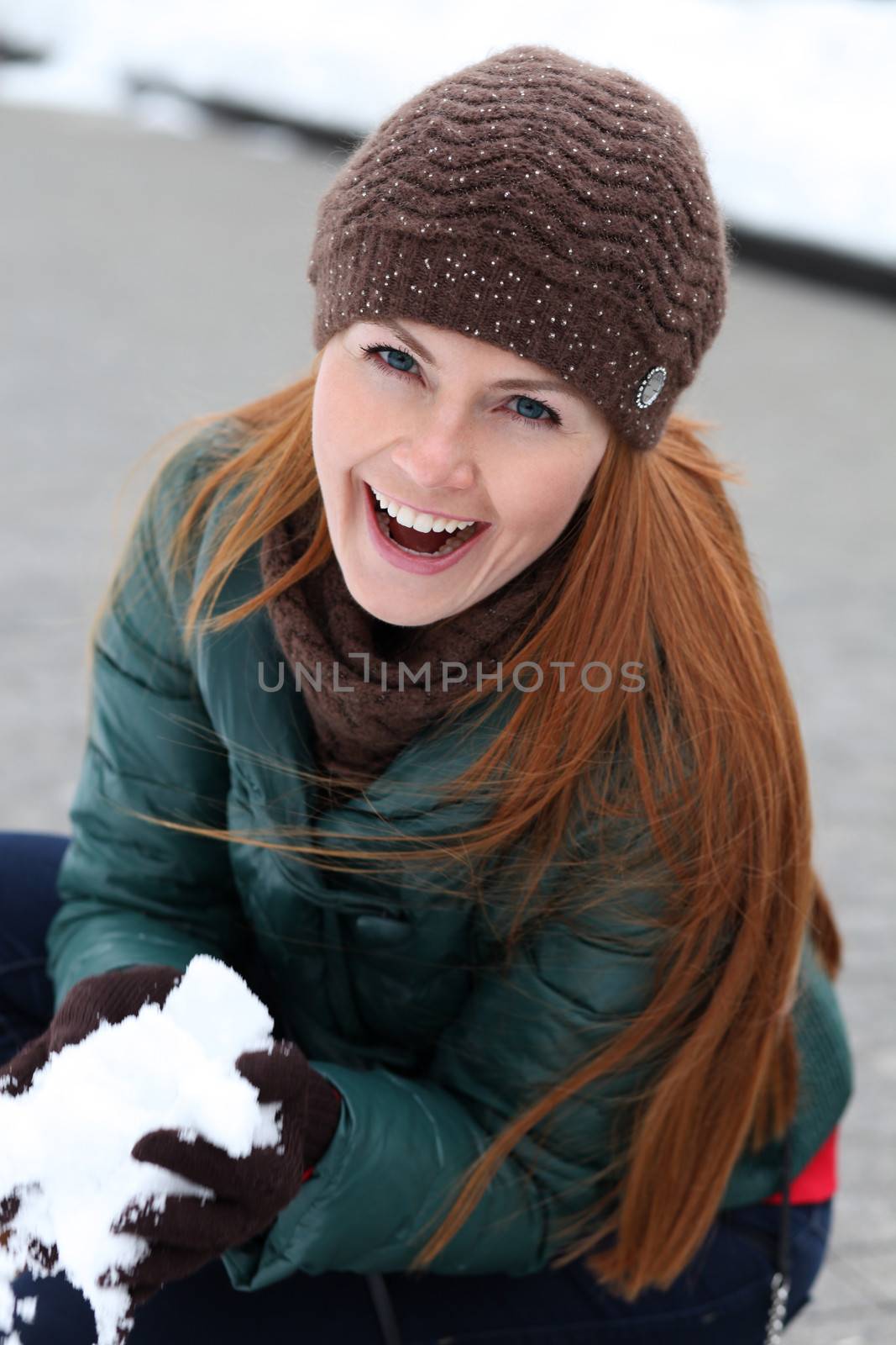 Happy young woman in winter city by andersonrise