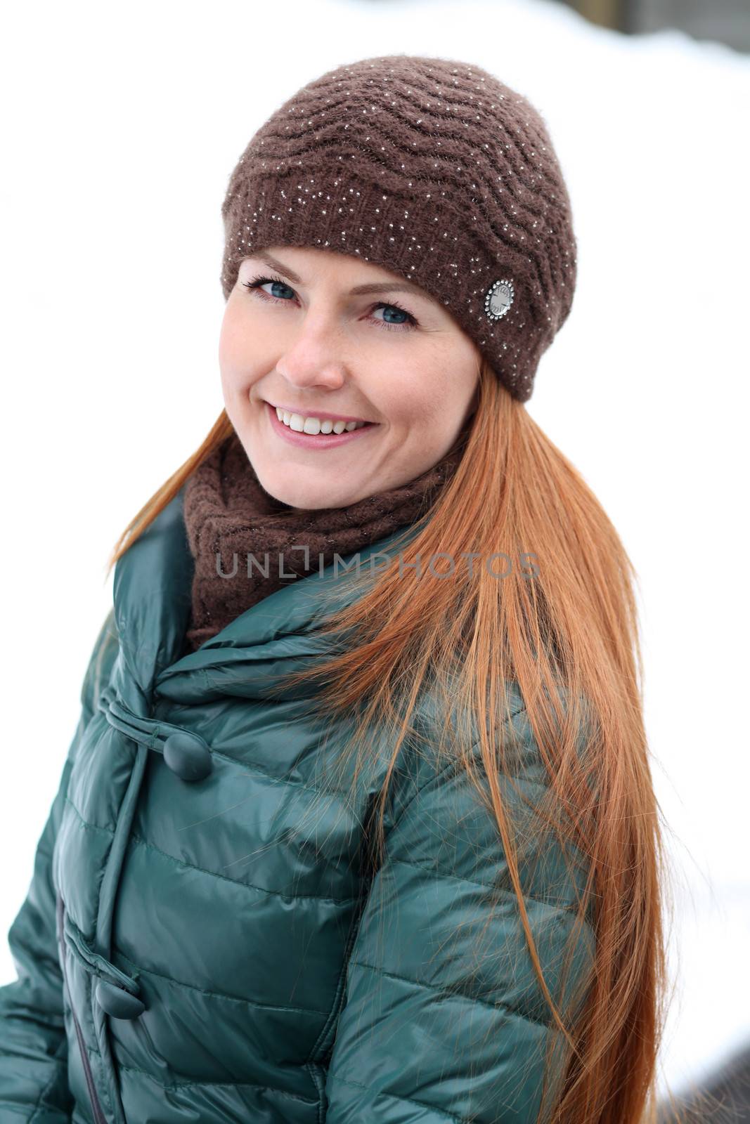 Happy young woman in winter city by andersonrise