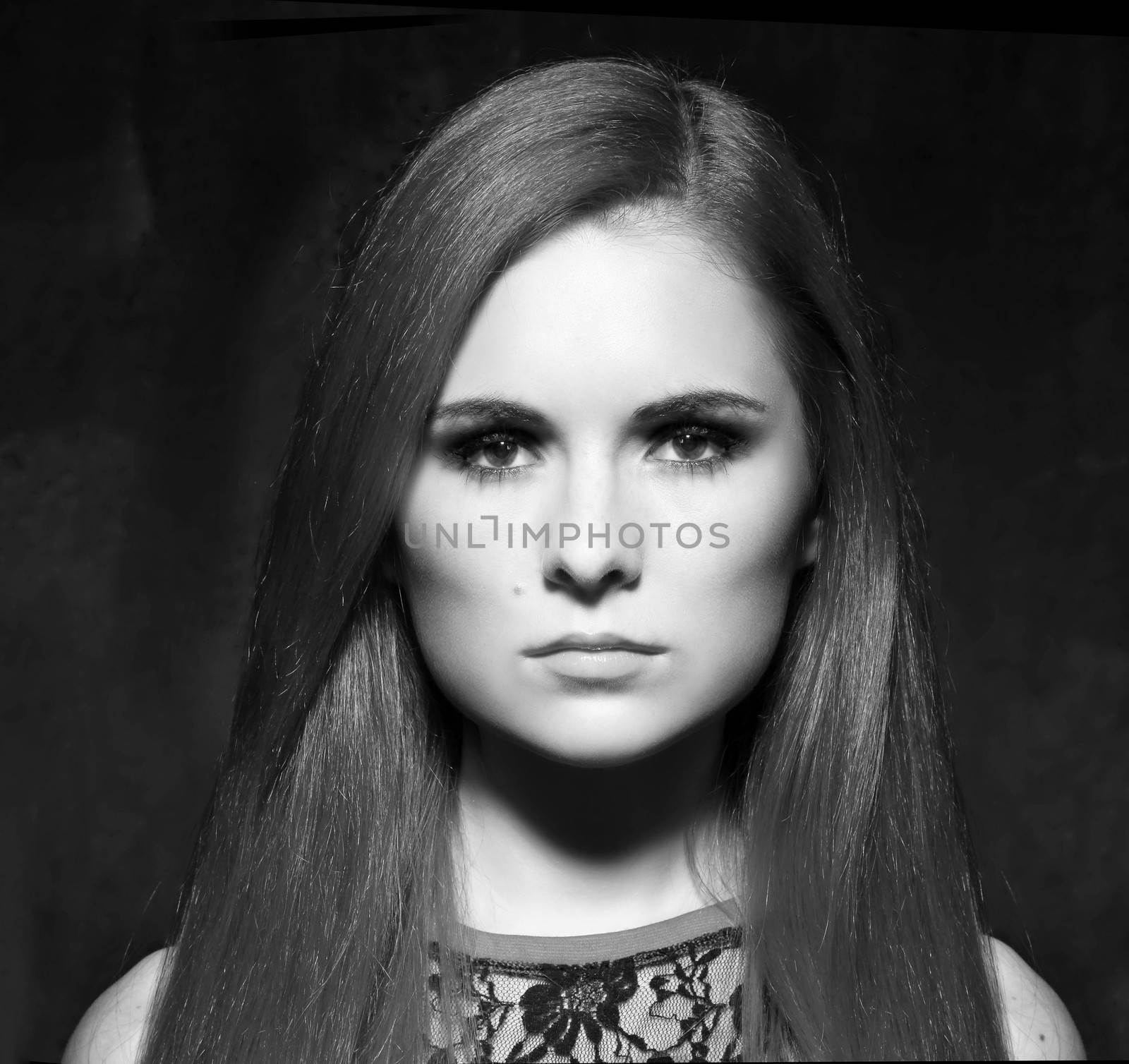 Young beautiful red hair woman in dark studio by andersonrise