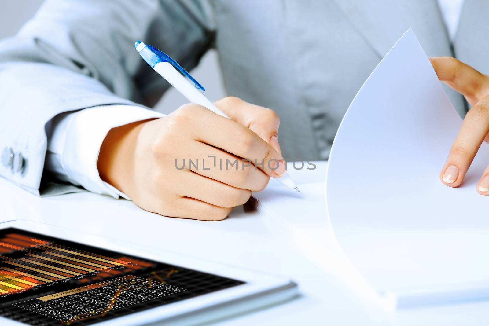 Image of businesswoman sitting at table and drawing sketch