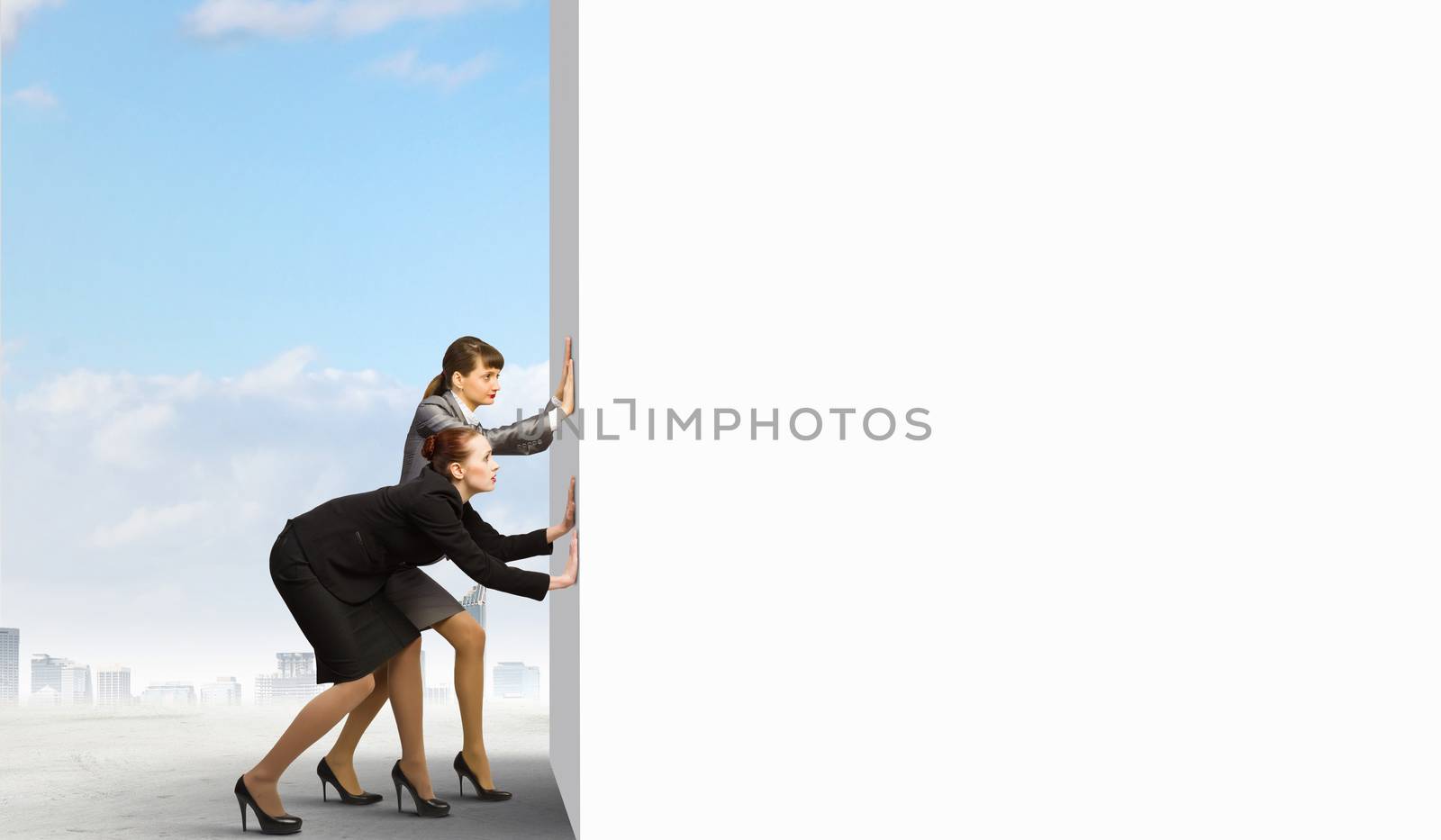 Two businesswoman pushing blank white banner. Place for text