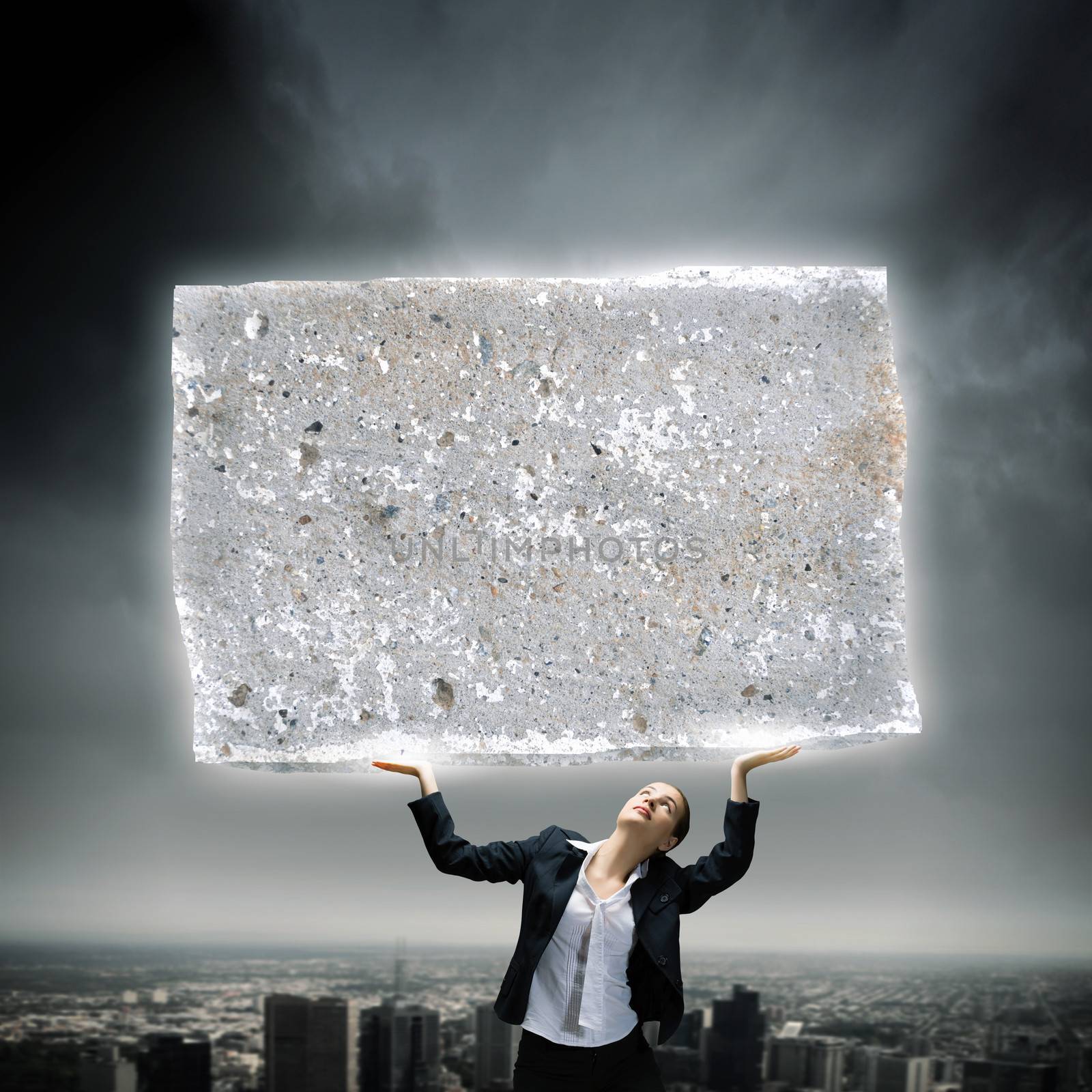 Image of young businesswoman holding burden above head