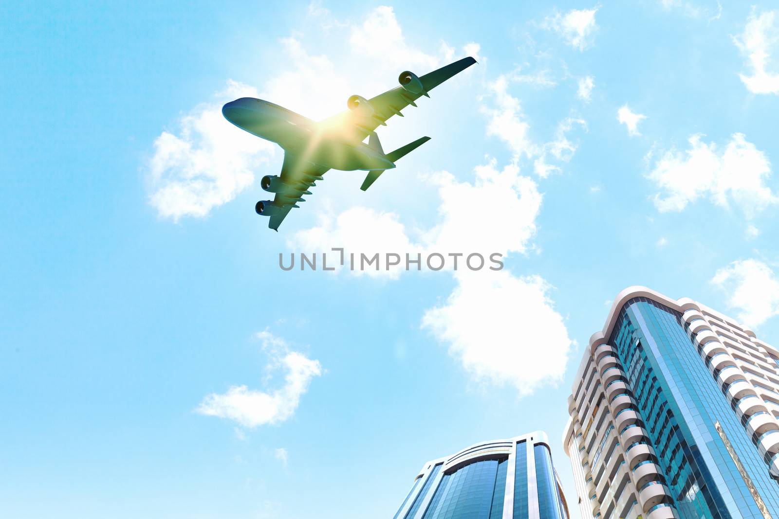 Image of airplane flying above skyscrapers. Bottom view