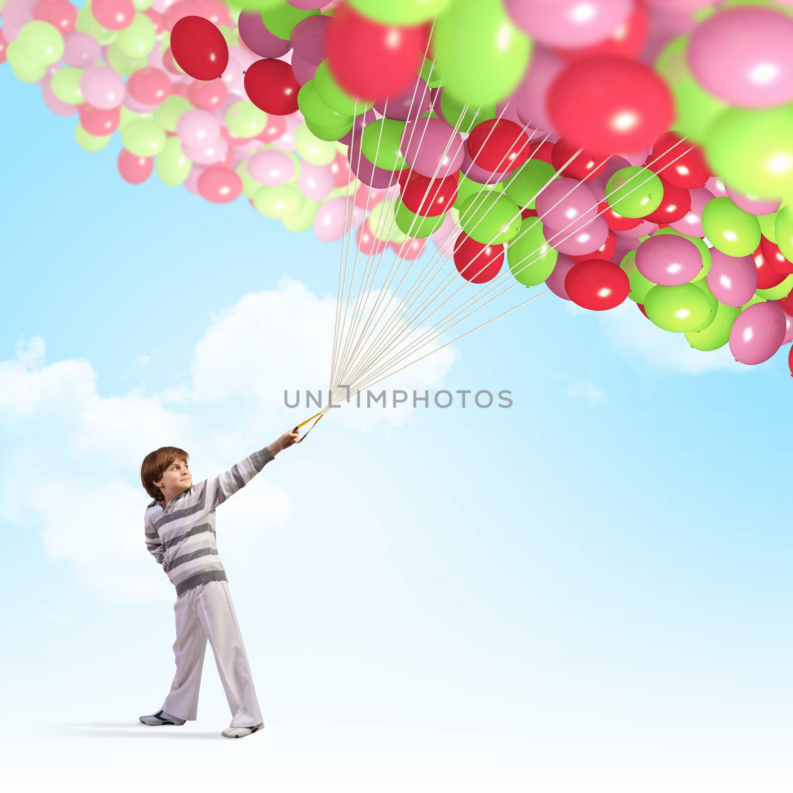 Image of little cute boy holding bunch of colorful balloons