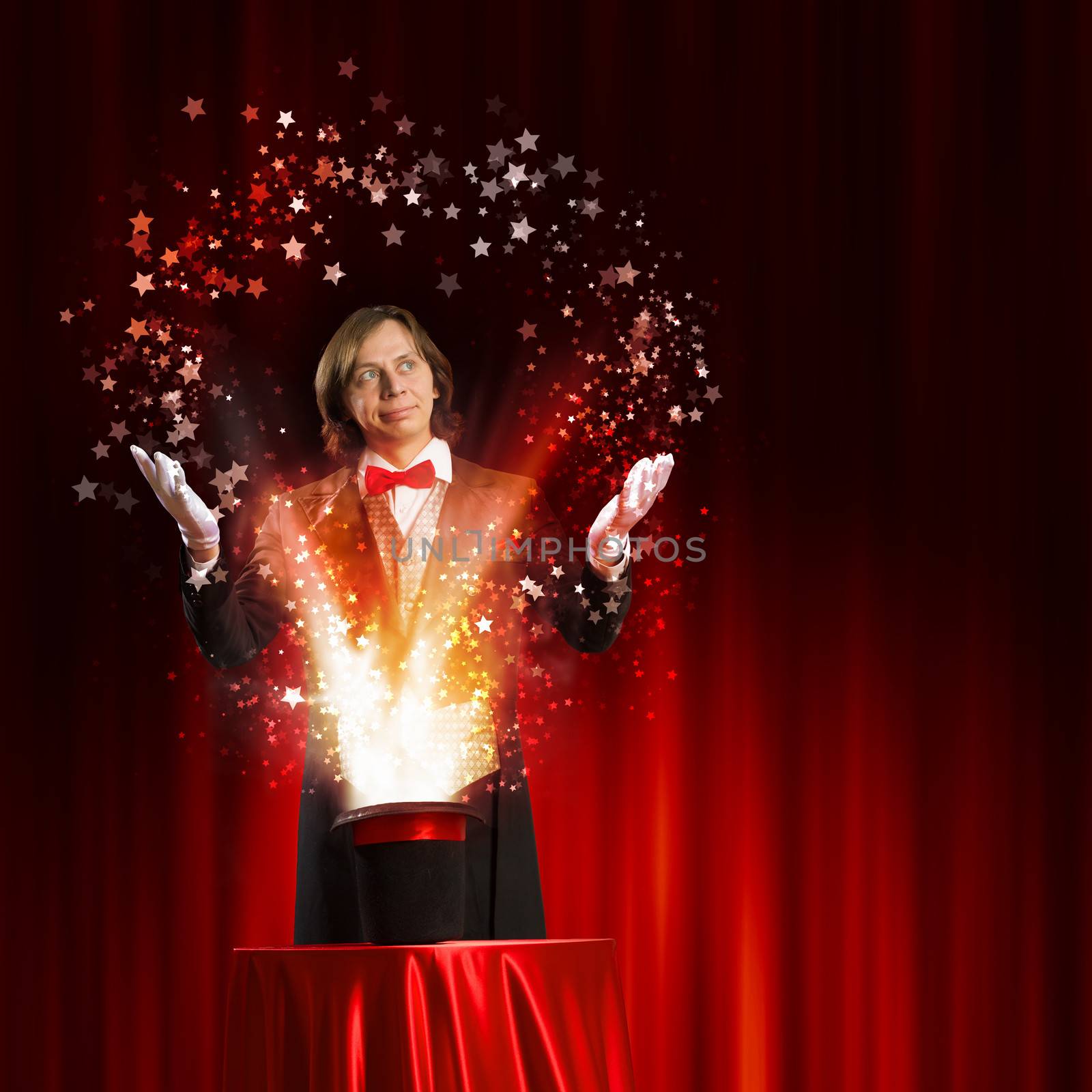 Image of magician holding hat with lights and fumes going out