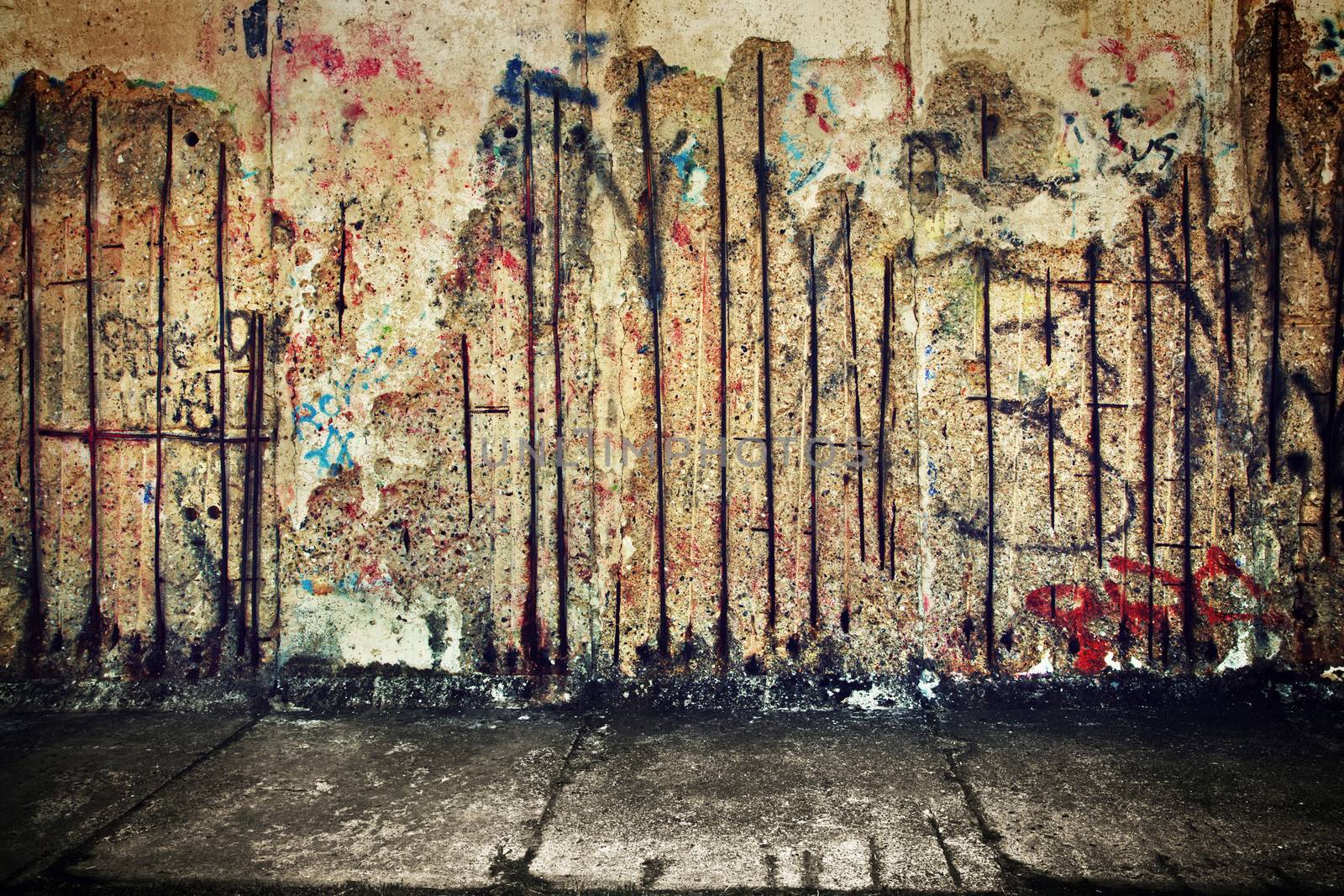 Grunge, rusty concrete wall with random graffiti by photocreo