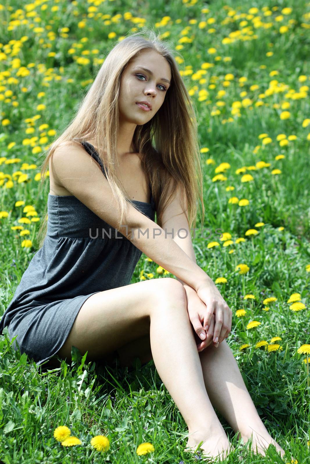 Beautiful young woman relaxing in the grass by andersonrise