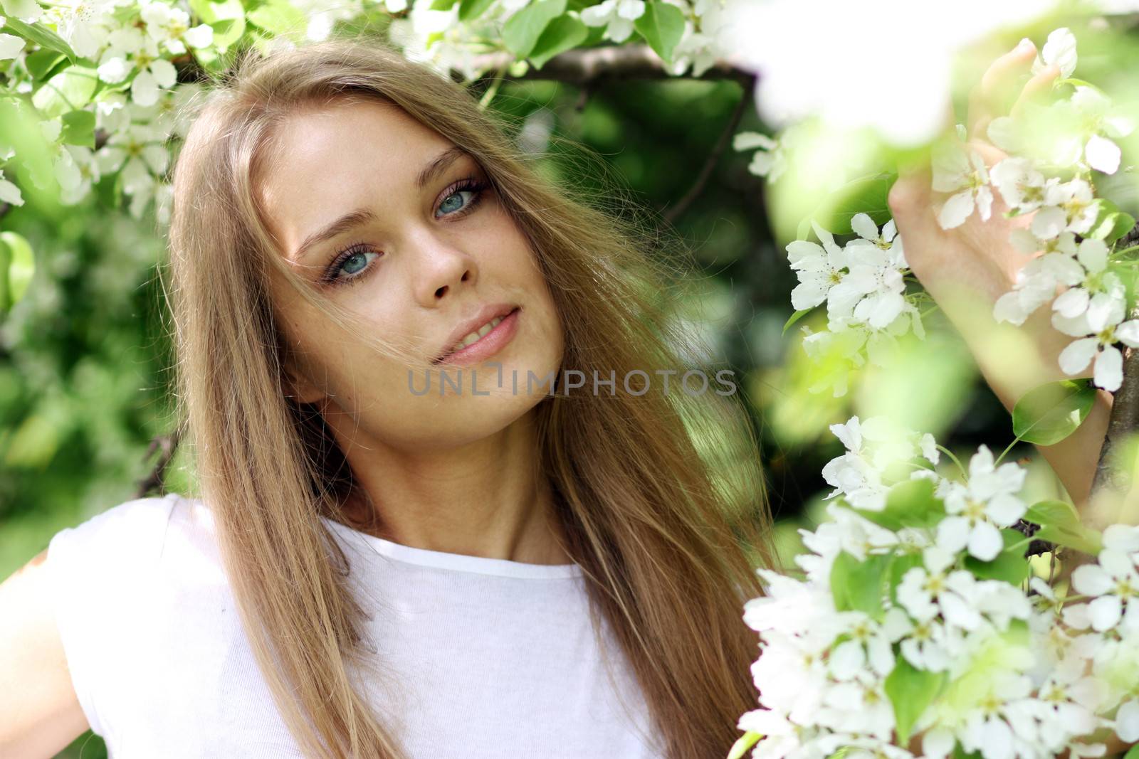 Portrait of beautiful blond in spring blossom