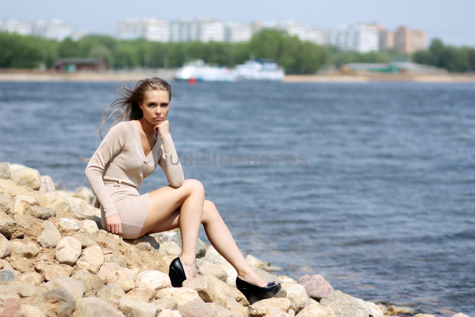 Portrait in full growth - young blonde woman in a sexual dress