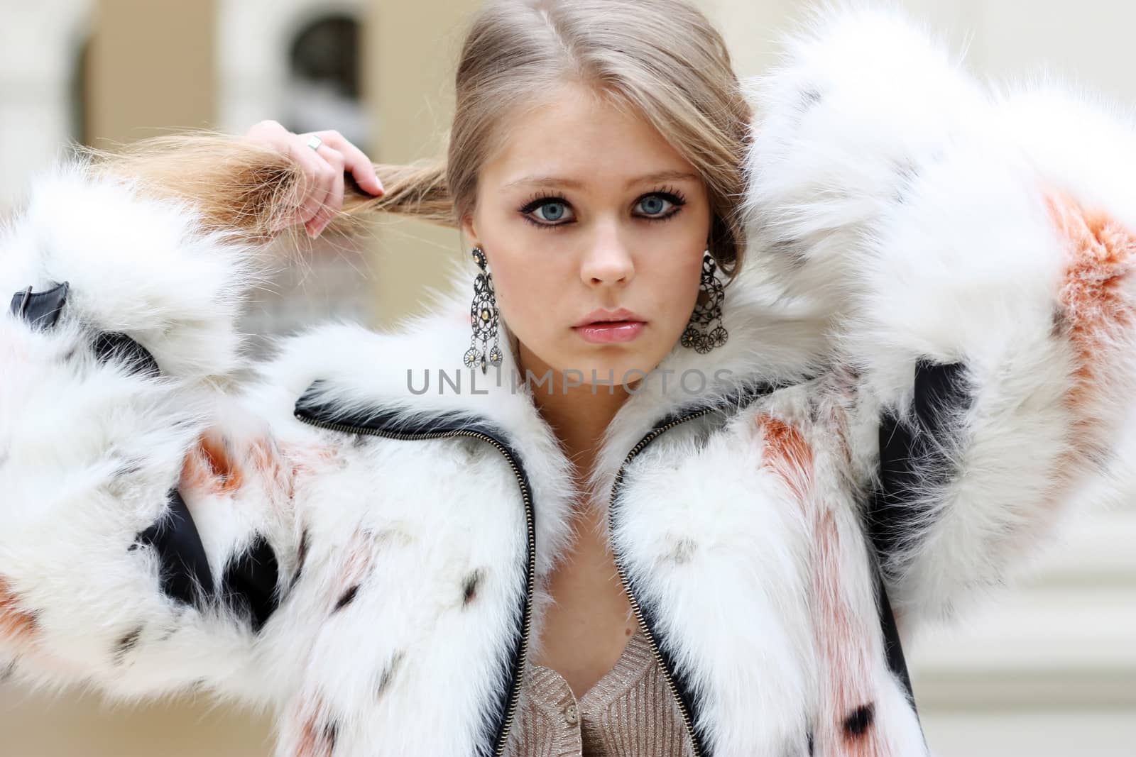 portrait of a beautiful happy woman in a knitted jacket by andersonrise