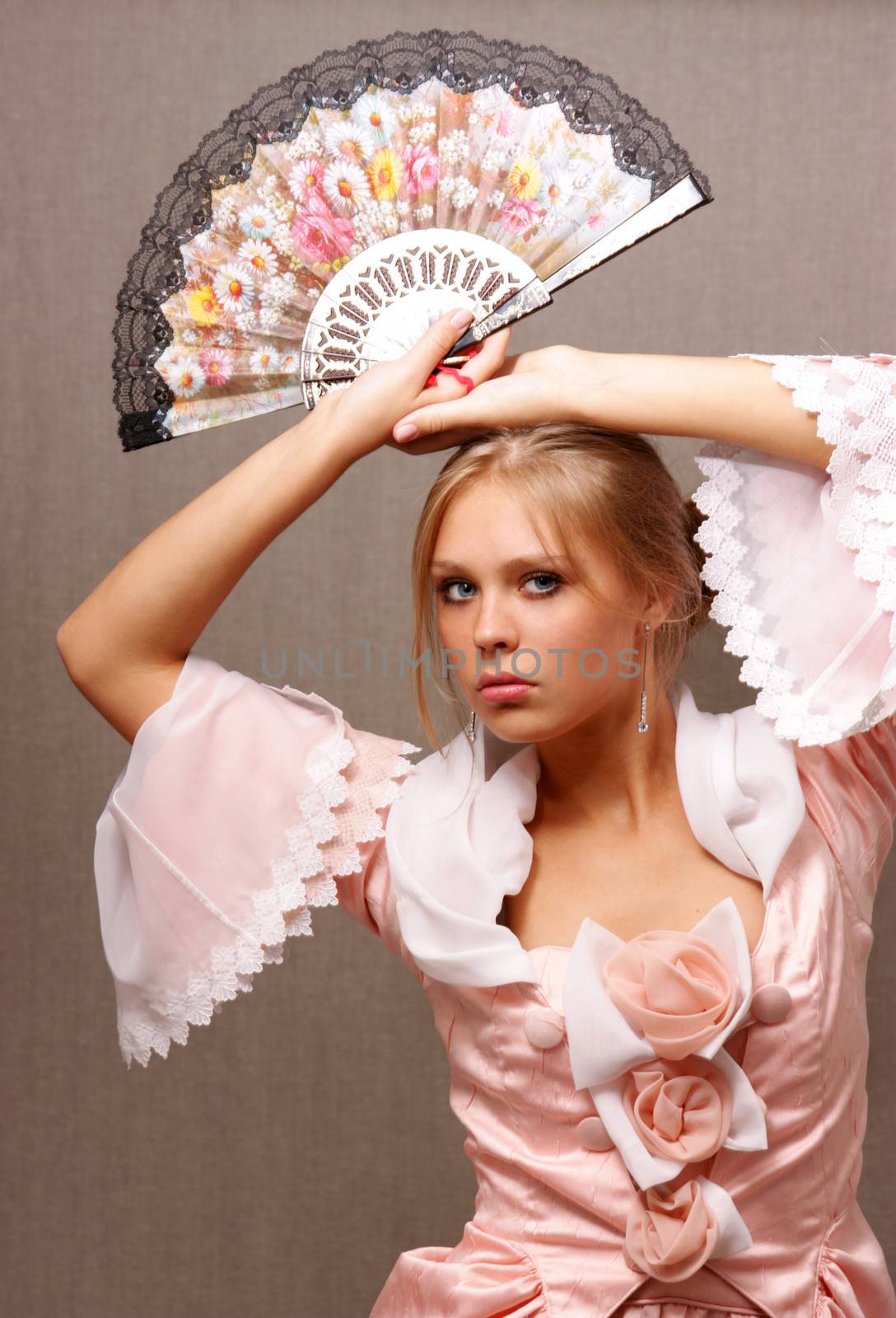 Young woman in a pink dress with a fan in hand by andersonrise