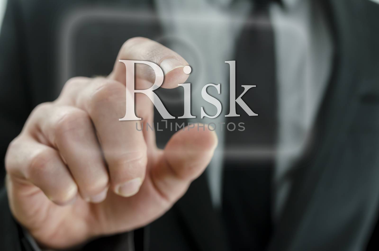 Close up of businessman hand pressing Risk icon on a virtual screen.