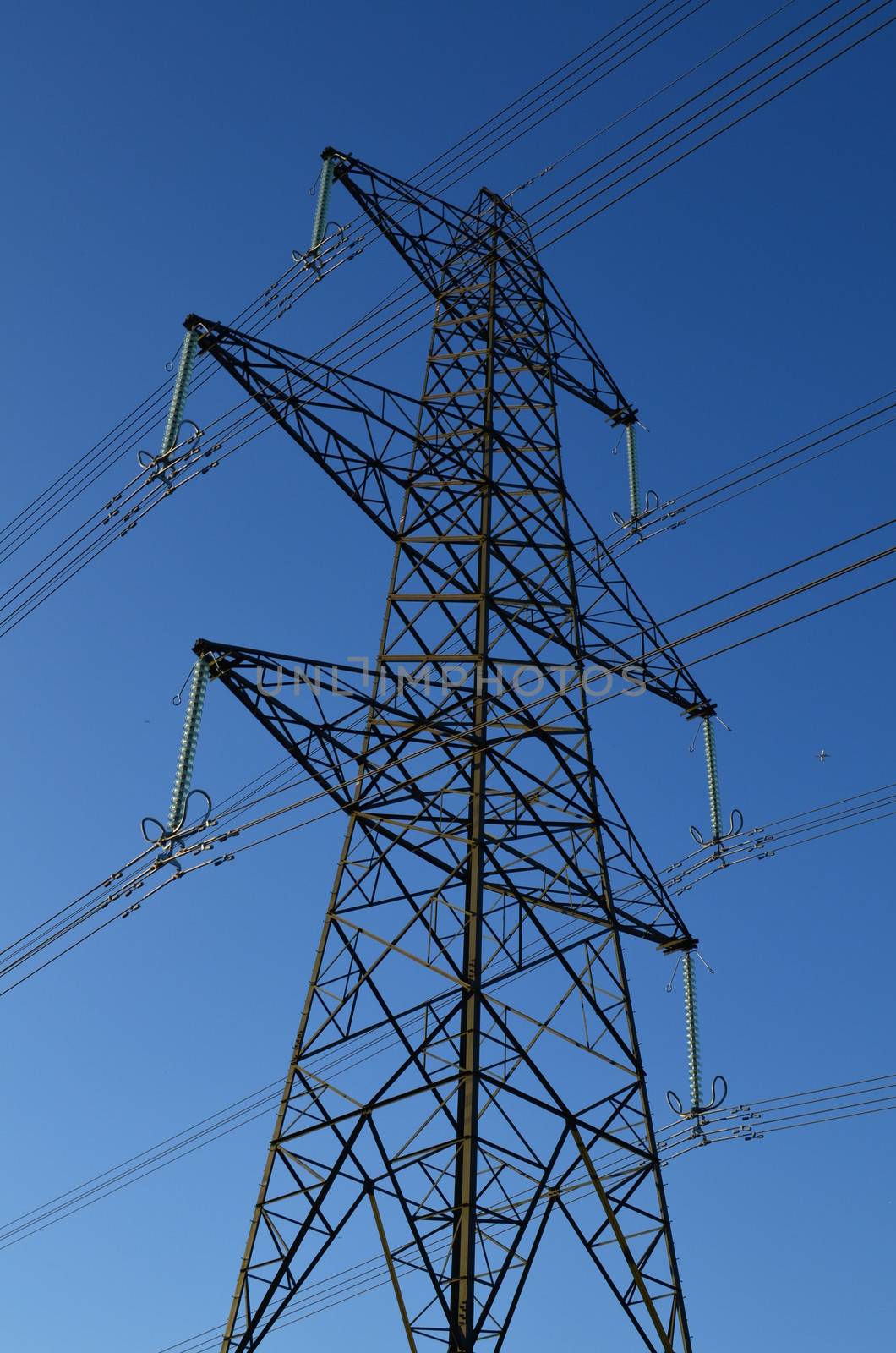 Power pylon in England under a blue sky.