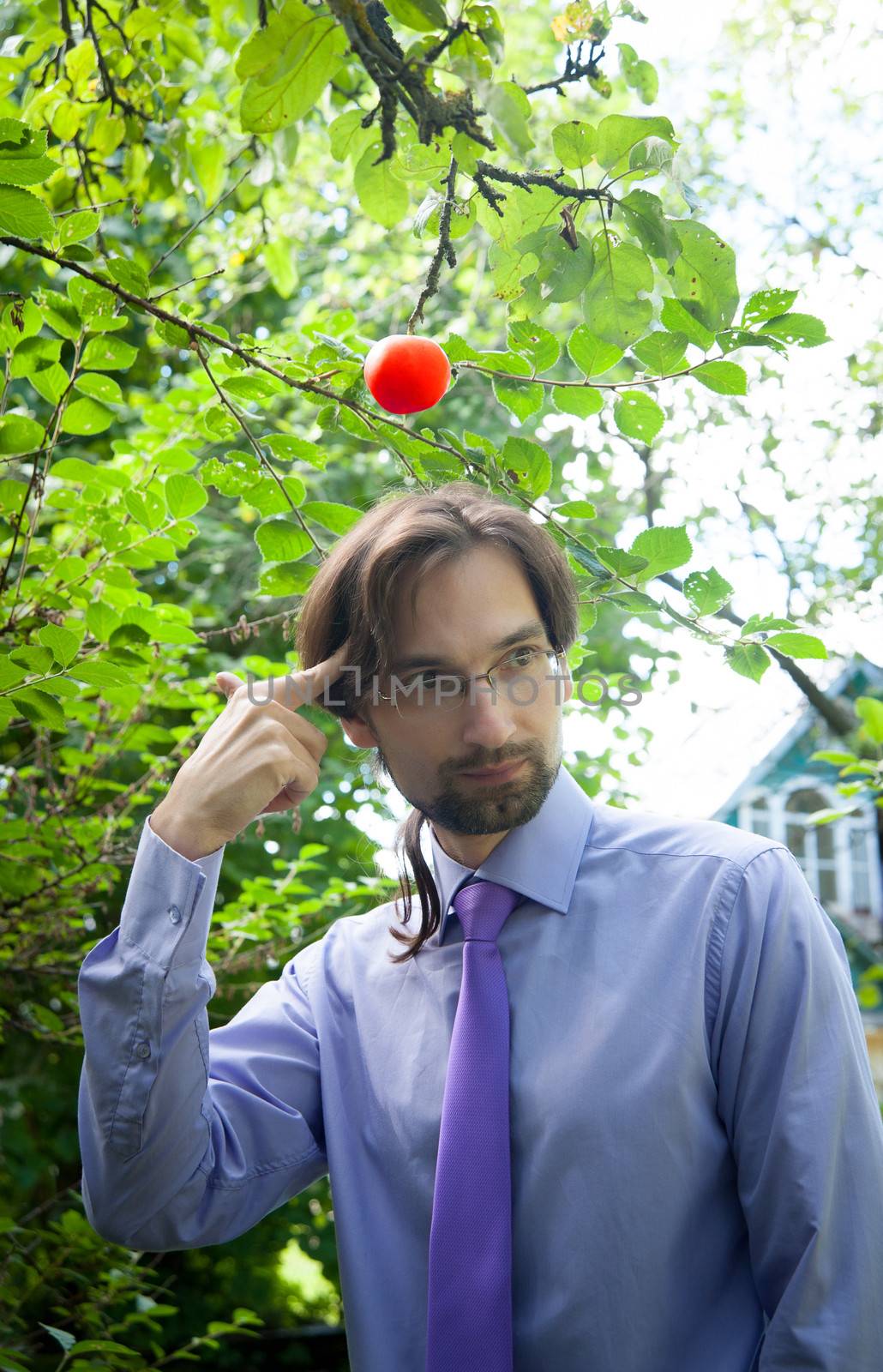 thinking man under the apple in the garden