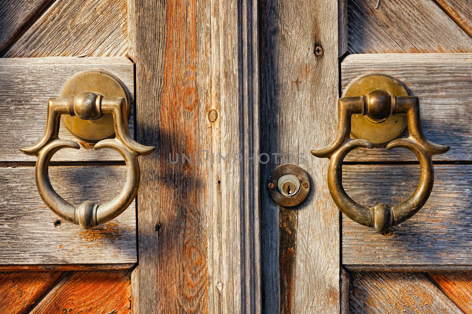 old brass door handles on wooden gate