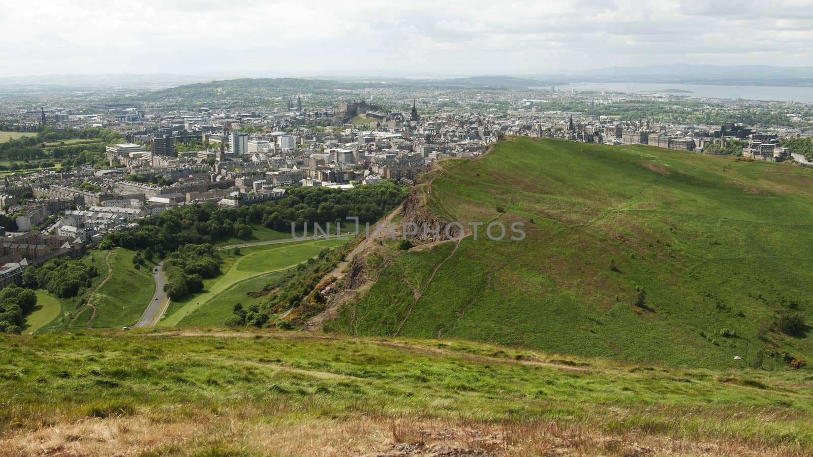 Arthur's Seat is the main peak of the group of hills which form most of Holyrood Park. It is situated in the centre of the city of Edinburgh, about a mile to the east of Edinburgh Castle. The hill rises above the city to a height of 250.5 m (822 ft), provides excellent panoramic views of the city, is relatively easy to climb, and is popular for hillwalking.