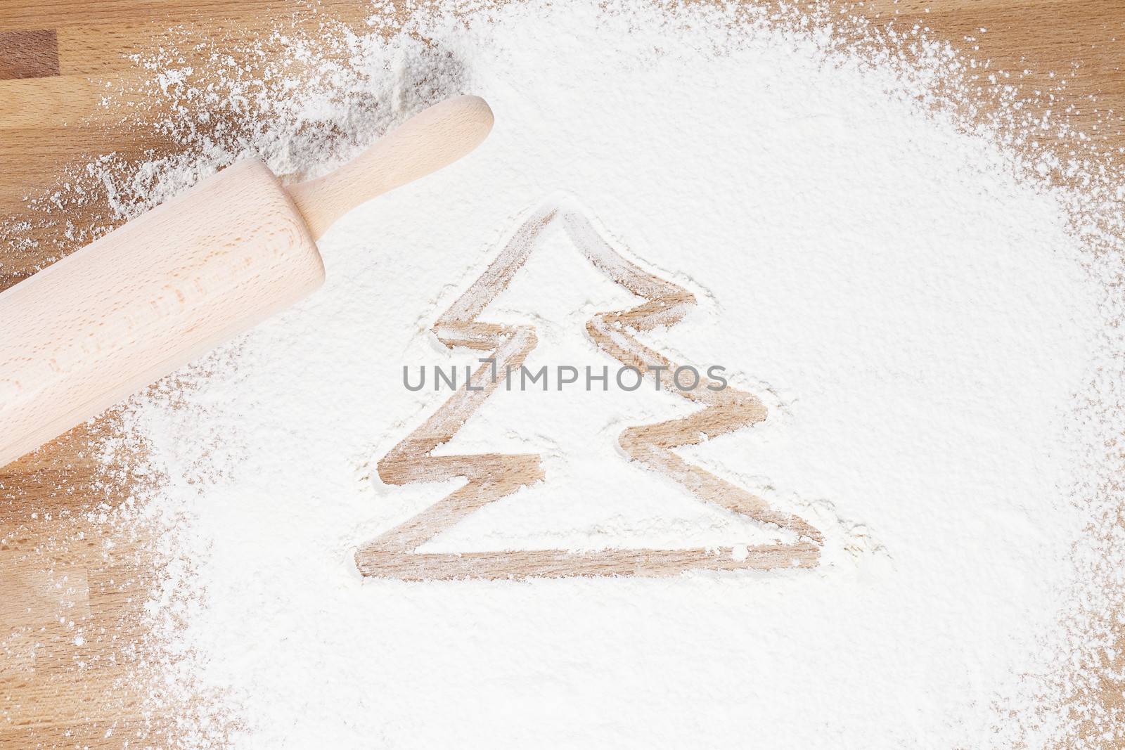 christmas tree drawn in flour with a rolling pin aside from top